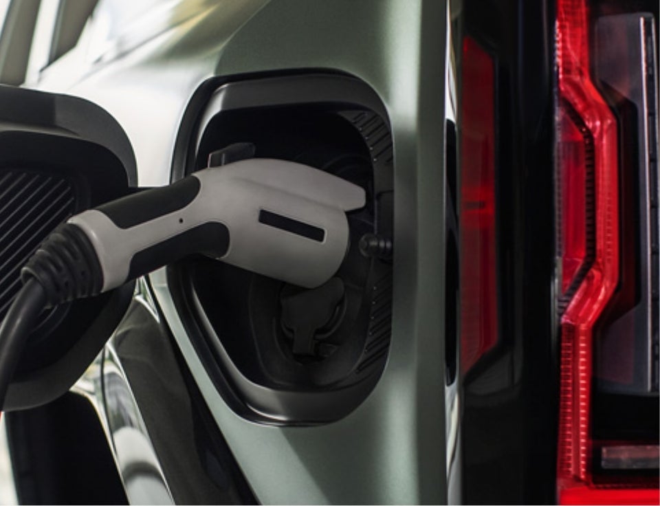 Close up of charging port with charger plugged in on a GMC Hummer EV SUV - Stoops Buick GMC of Muncie in MUNCIE IN